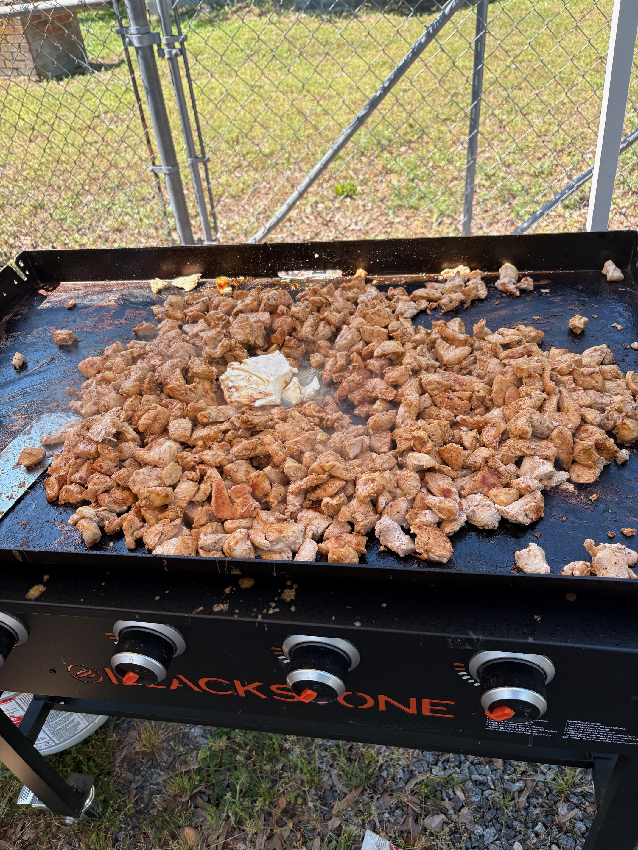 Hibachi chicken cooking fresh on the flat-top griddle